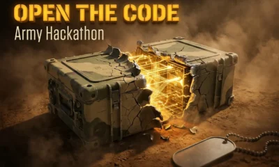 Cracked military comms chassis exposes glowing amber AI lattice at Fort Carson hackathon.