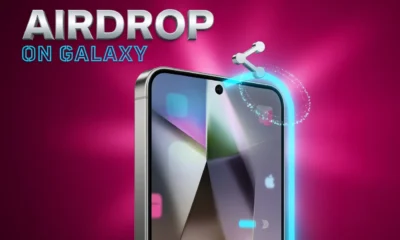 Samsung Galaxy phone glass display showing One UI 8.5 update with AirDrop file transfer feature.