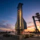 SpaceX Starship rocket on launch pad pre-dawn before IPO listing