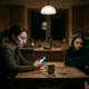 Parent distracted by phone while teen sits nearby