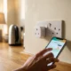 Tapo P110 plug showing real-time appliance energy use on a phone